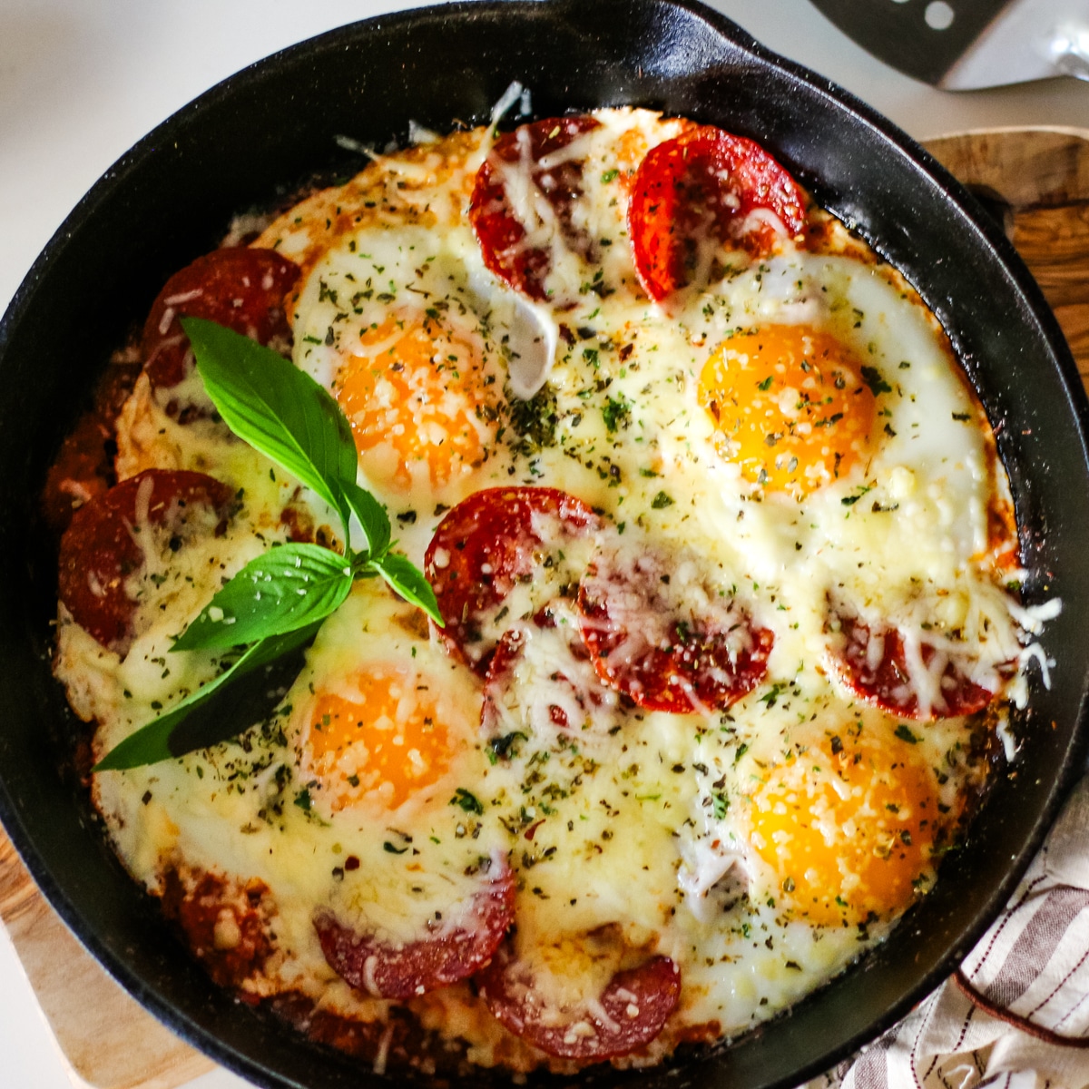 pizza egg on a pan topped with herbs.