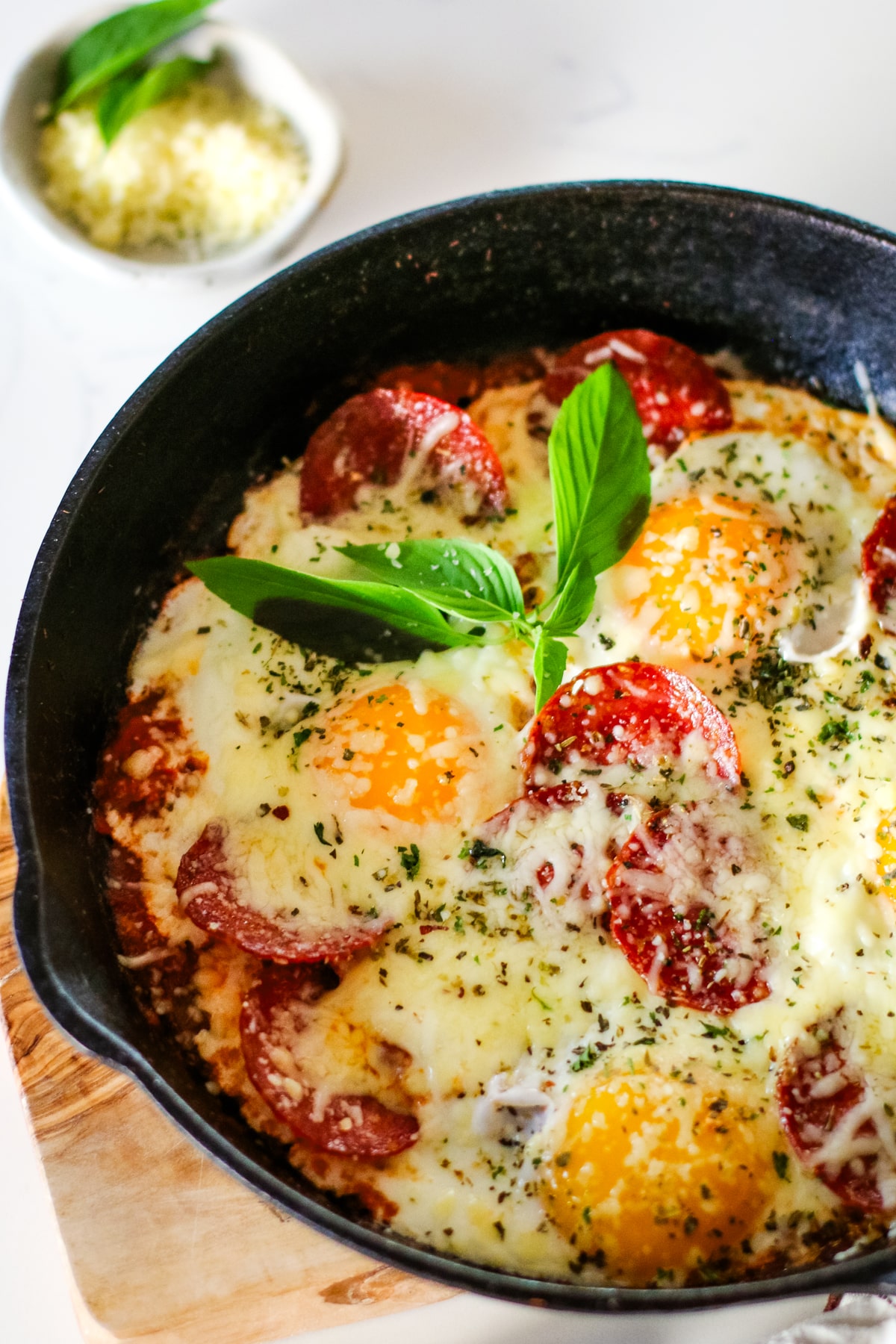pizza egg on a pan topped with herbs.