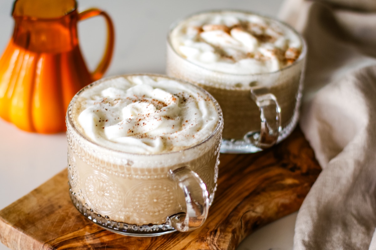 pumpkin spice latte served in a coffee glass.