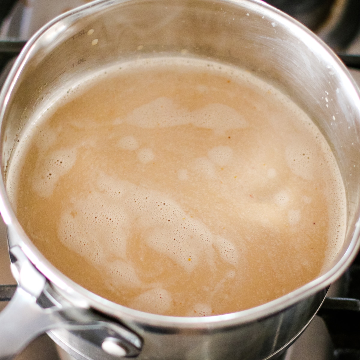 pumpkin spice latte whisked in a small saucepan.