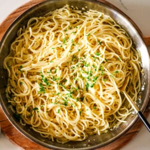 garlic butter pasta in a pan with a fork.
