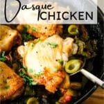 basque chicken in a skillet with a serving spoon.