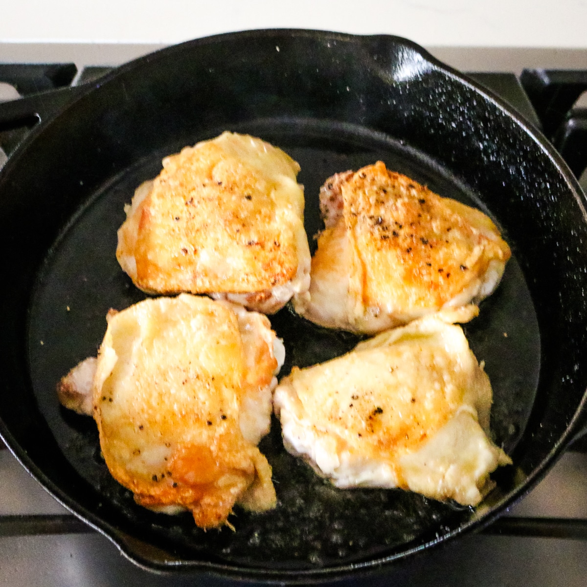 cooking chicken in a skillet.