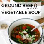 ground beef and vegetable soup in a pot and served in a bowl.