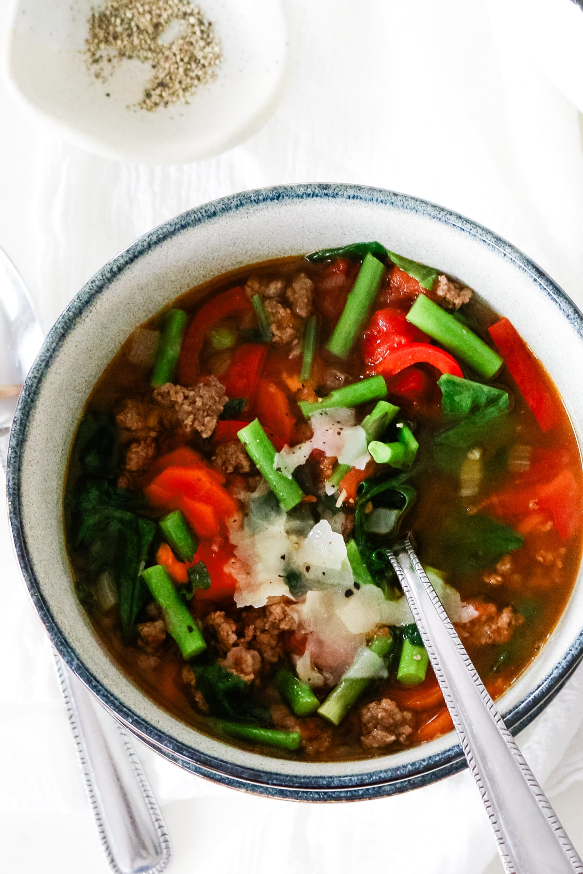 ground beef and vegetable soup served in a bowl.