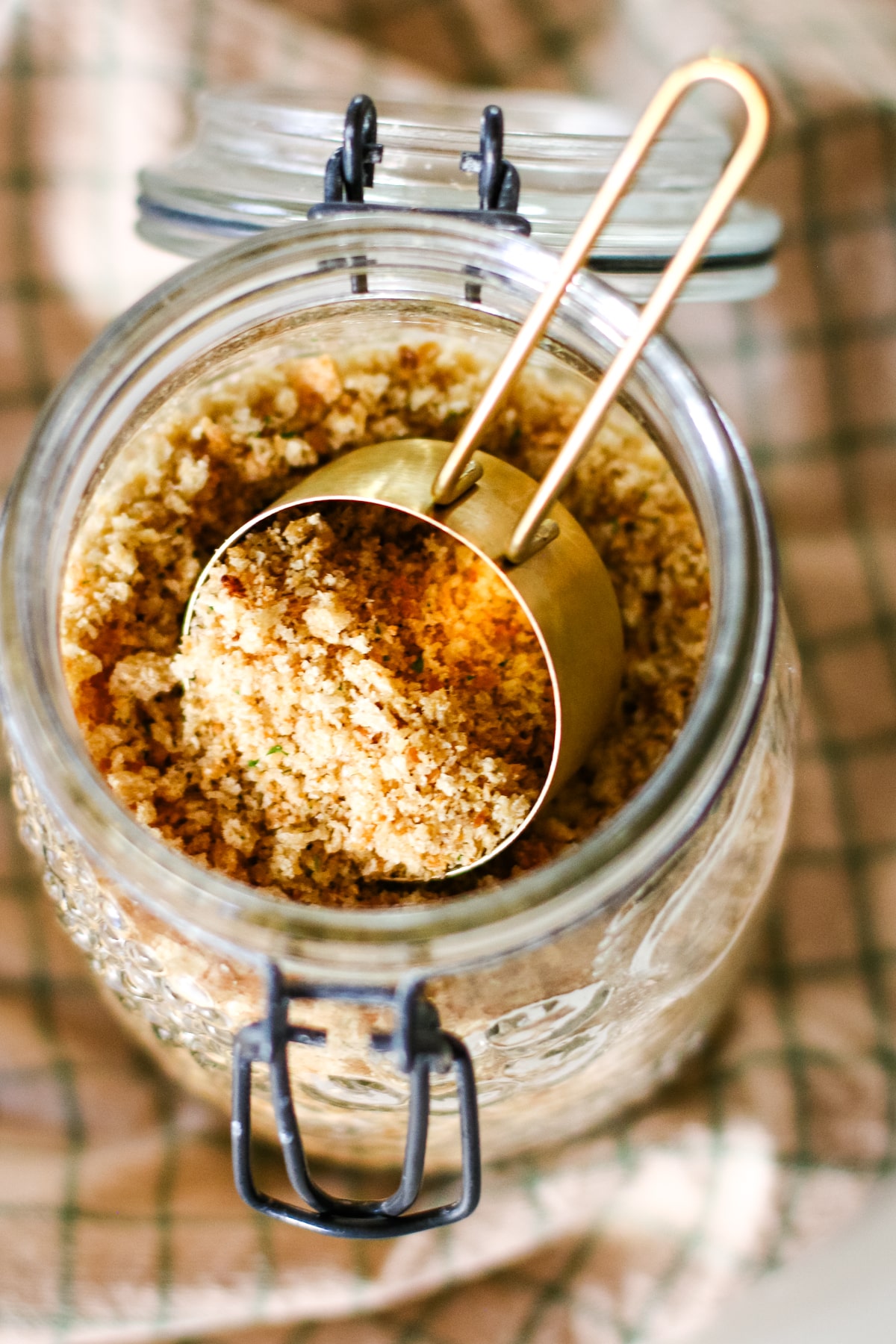 breadcrumbs in a jar with a scooper.