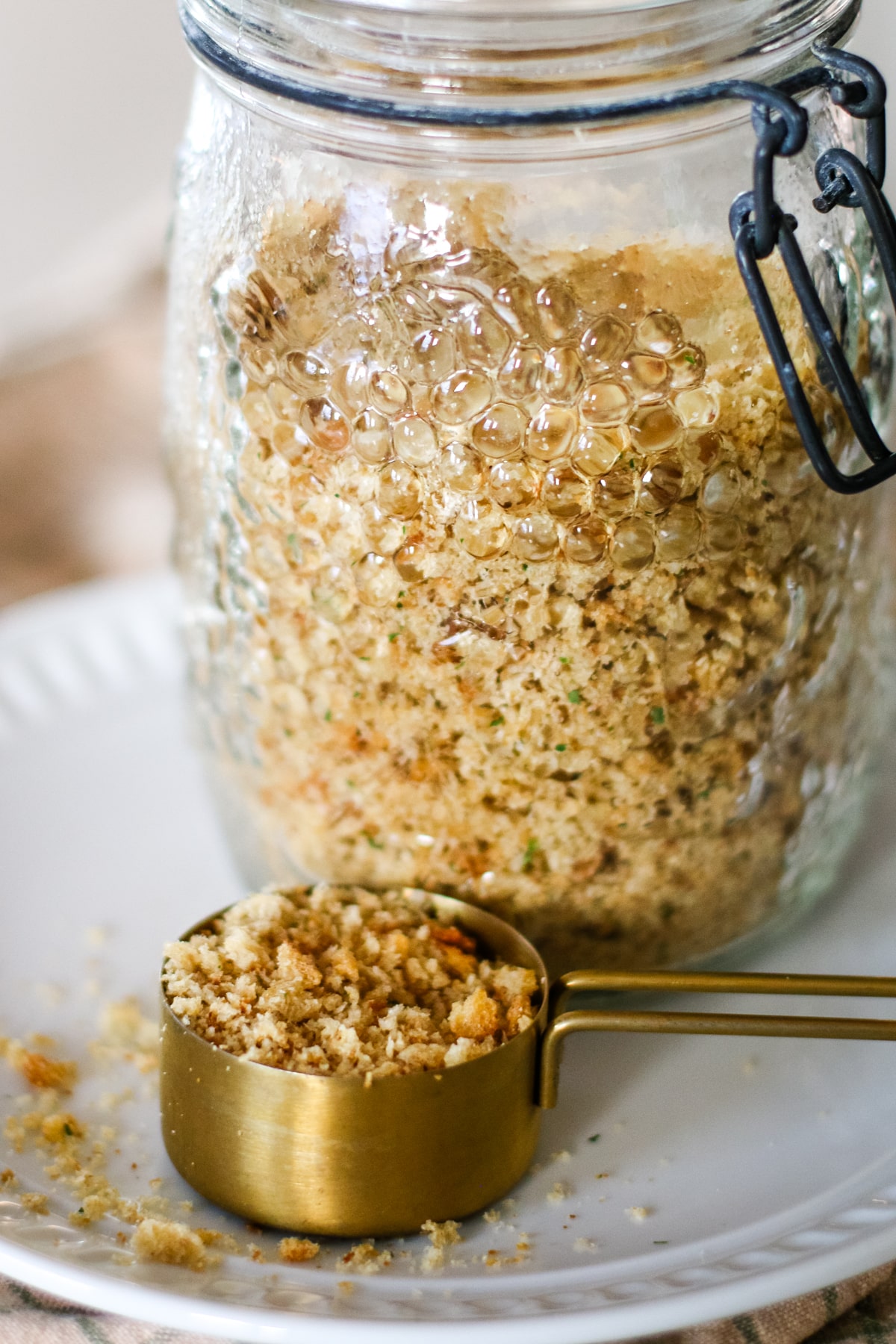 breadcrumbs in a jar with a scooper.