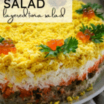 layered mimosa salad with tuna and egg.
