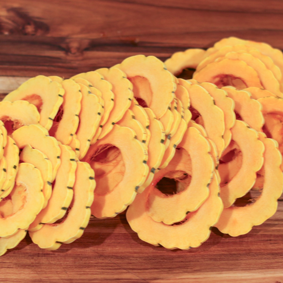 delicata squash sliced and arranged evenly in a baking dish for even cooking.