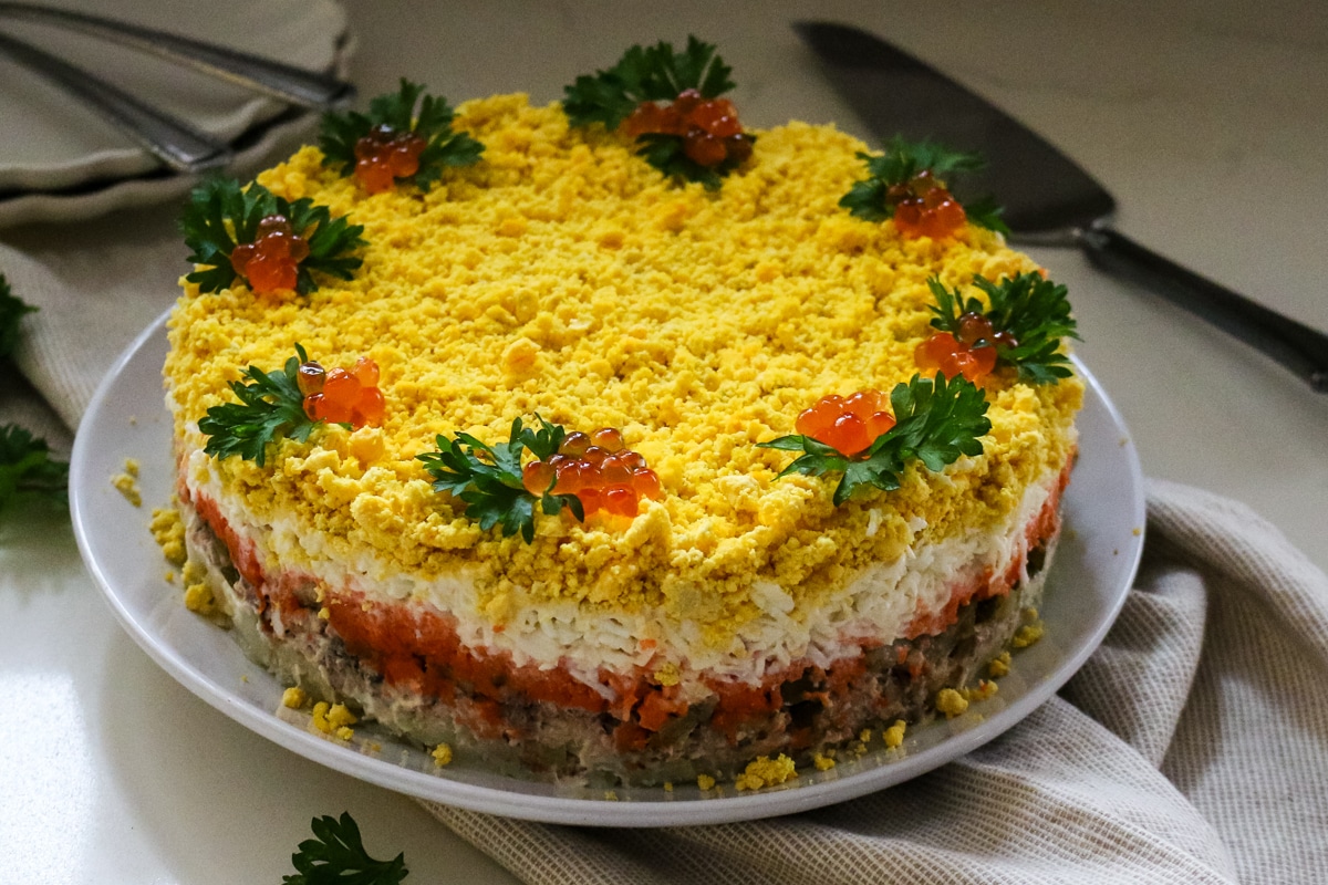 layered mimosa salad with tuna and egg.