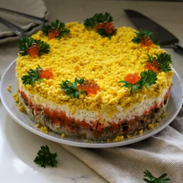 layered mimosa salad with tuna and egg.