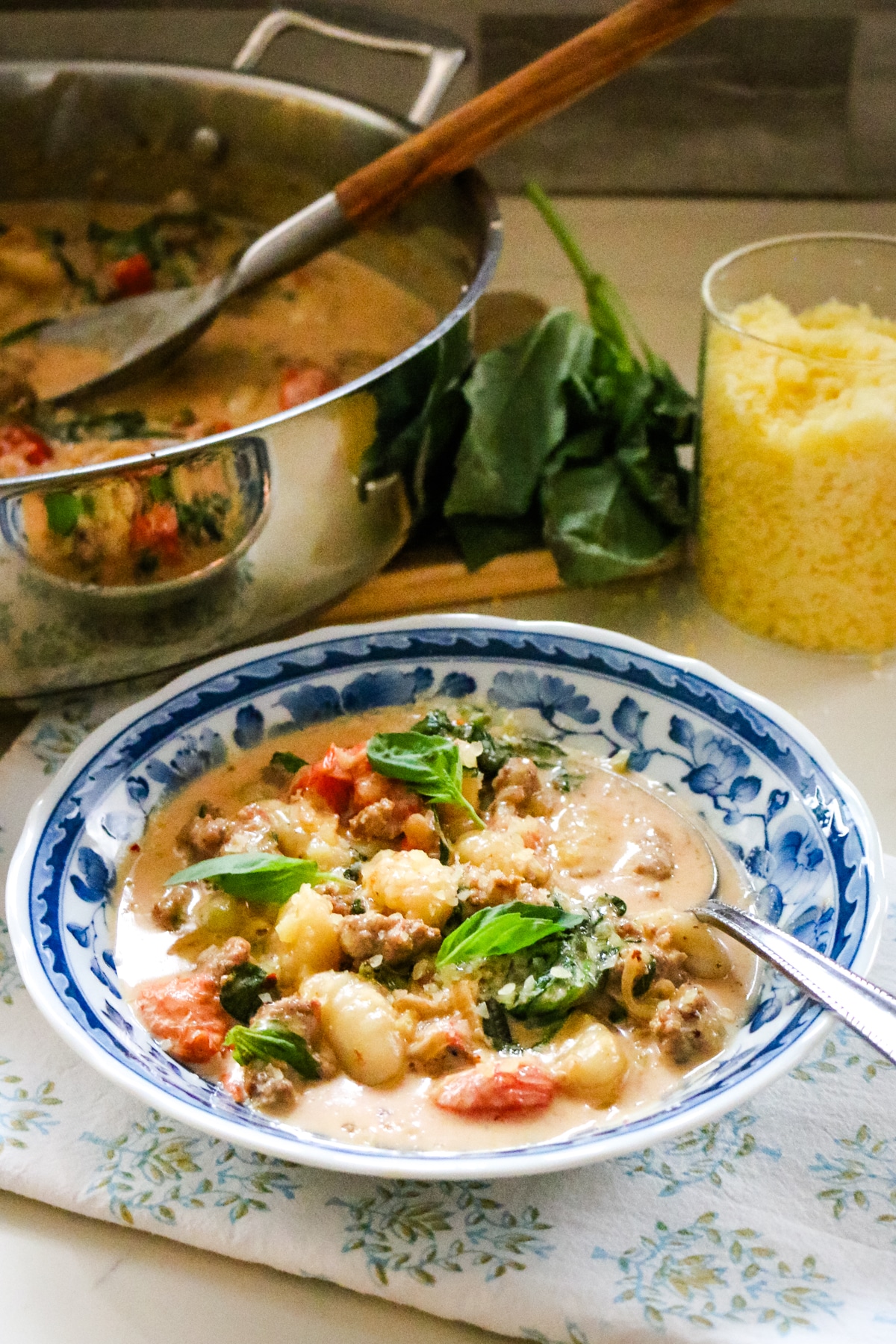 creamy sausage and gnocchi in a bowl and pan.