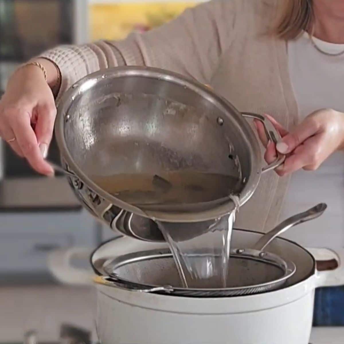 Strained broth poured into the pot.