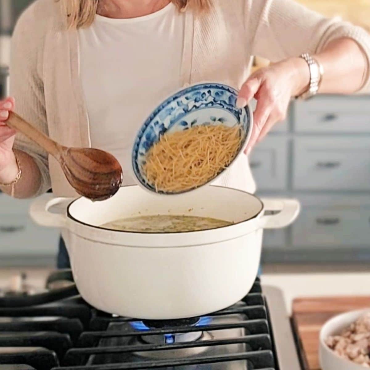 Soup boiling with pasta added.