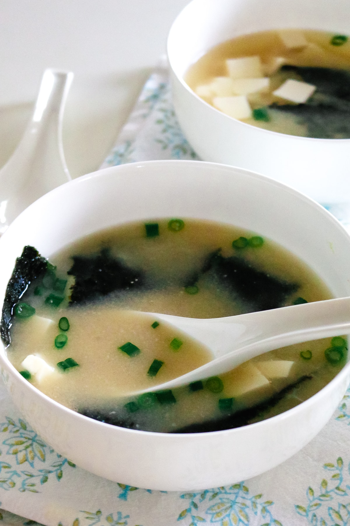Warm miso soup with seaweed and tofu served in a simple ceramic bowl.