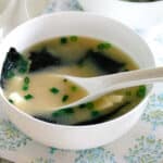 Warm miso soup with seaweed and tofu served in a simple ceramic bowl.