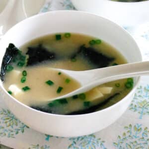 Warm miso soup with seaweed and tofu served in a simple ceramic bowl.