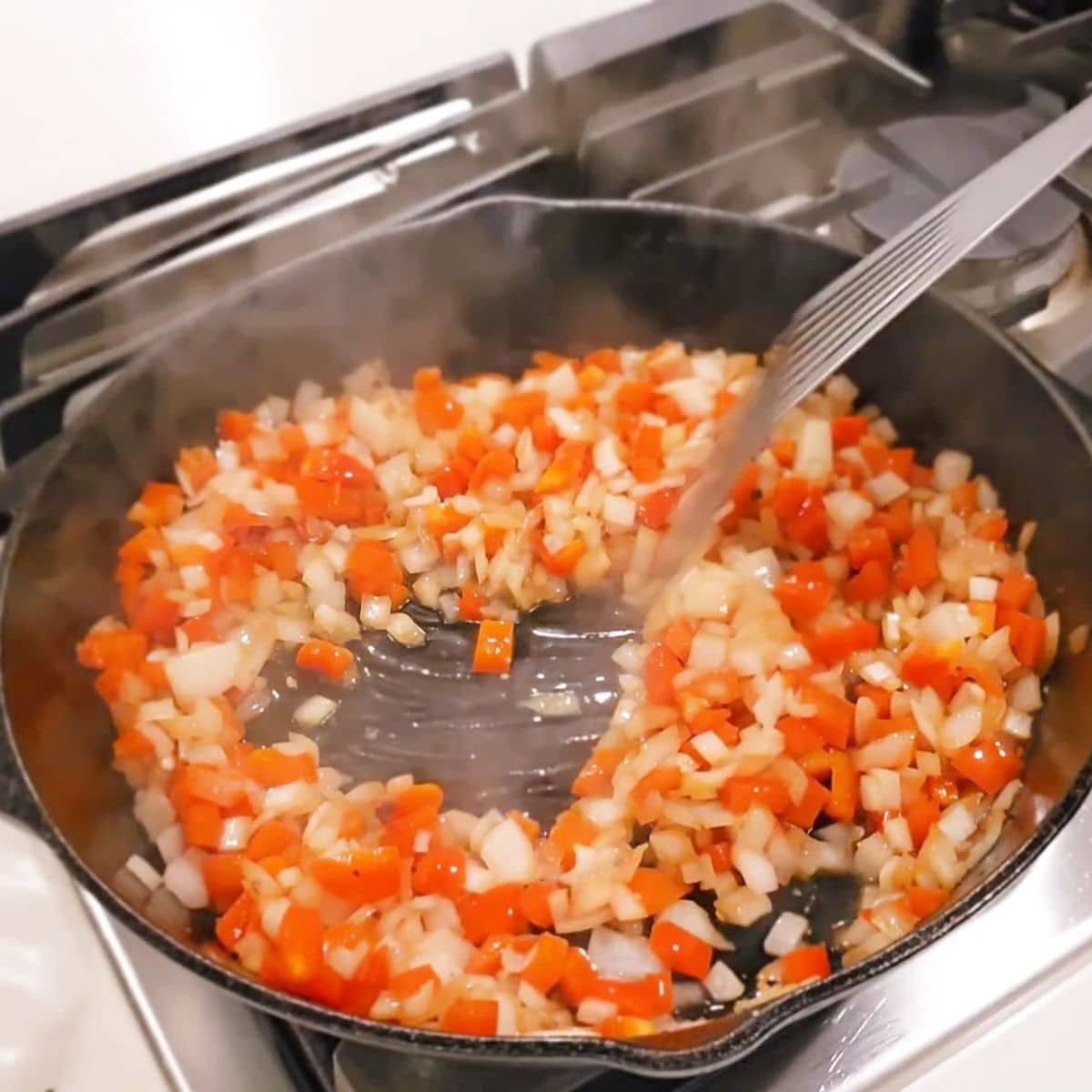bell peppers and onions sauted in a cast iron skillet.