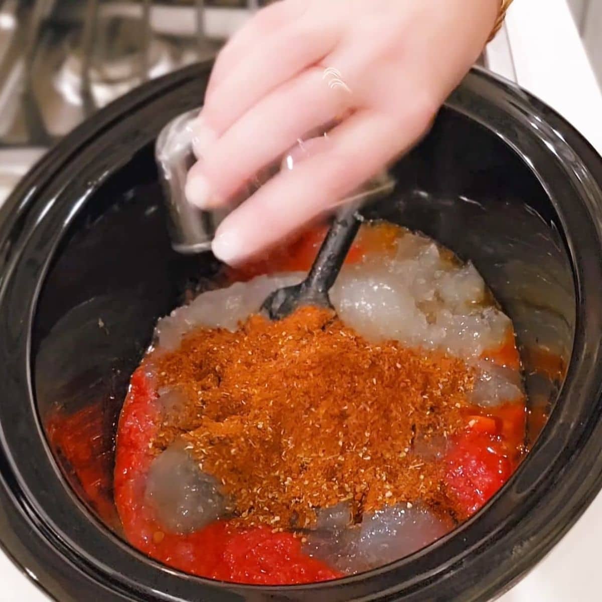 crushed tomatoes, bone broth, seasonings added to slow cooker.