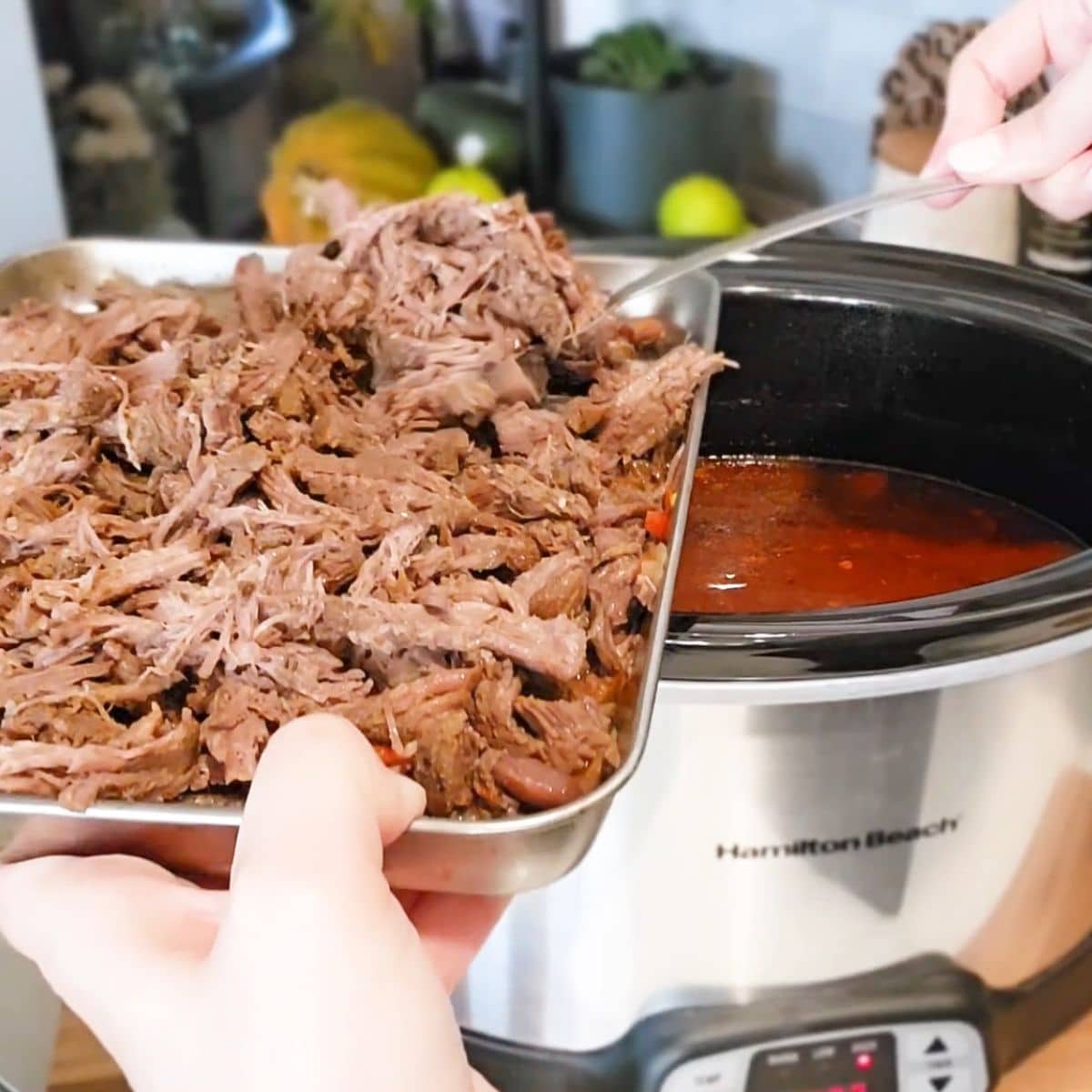 shredded beef added to chili in slow cooker.