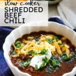 shredded beef chili with toppings with text overlay.