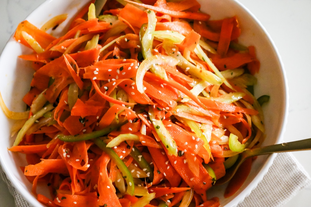 shaved carrot ribbons with celery and bell pepper and sesame seeds.