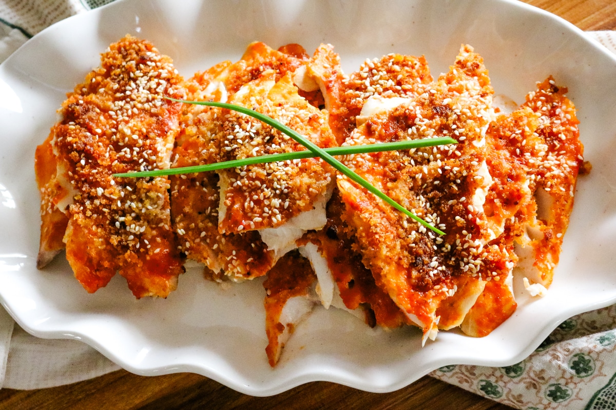 panko crusted white fish with sesame seeds and green onions.