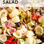 italian pasta salad in a bowl with text overlay saying italian pasta salad and prepare and nourish logo on the bottom right.