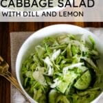 A bowl of fresh cucumber cabbage salad with dill, featuring text that reads: "CUCUMBER CABBAGE SALAD WITH DILL AND LEMON."