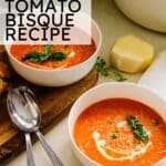 Pinterest pin with text overlay reading EASY TOMATO BISQUE RECIPE showing two white bowls of creamy tomato soup garnished with basil and cream swirls.