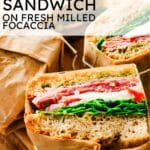 Text overlay reading 'Italian Sandwich on Fresh Milled Focaccia' above parchment-wrapped gourmet sandwiches tied with twine, highlighting fresh-milled focaccia bread, pesto, sliced meats, and fresh greens.