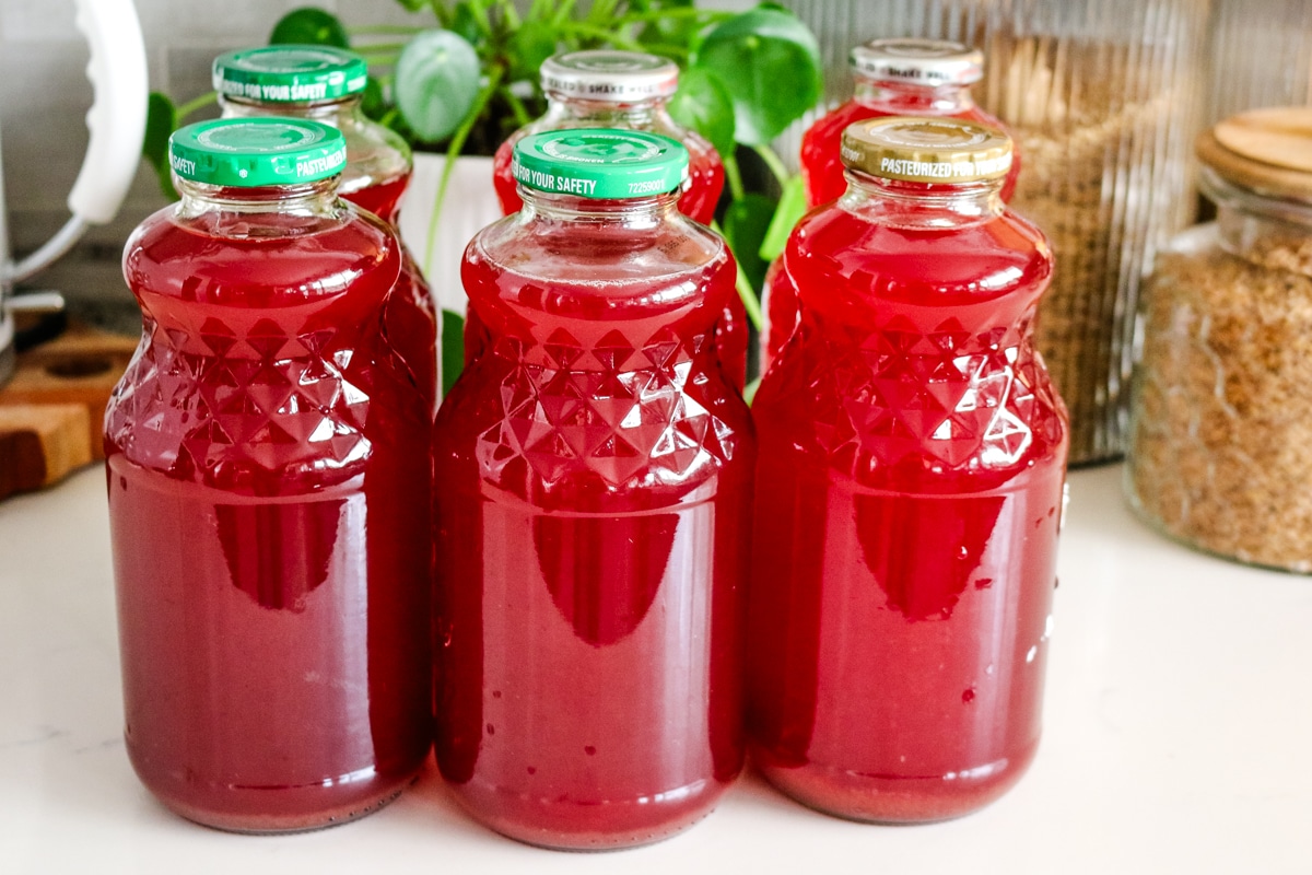 six jars filled with homemade kompot.