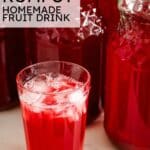 Text graphic reading "KOMPOT HOMEMADE FRUIT DRINK" over an image of iced kompot in a glass next to glass jars.
