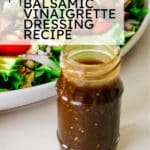 photo of balsamic vinaigrette dressing in a jar infront of a white bowl full of salad with text overlay saying "homemade balsamic vinaigrette dressing recipe".