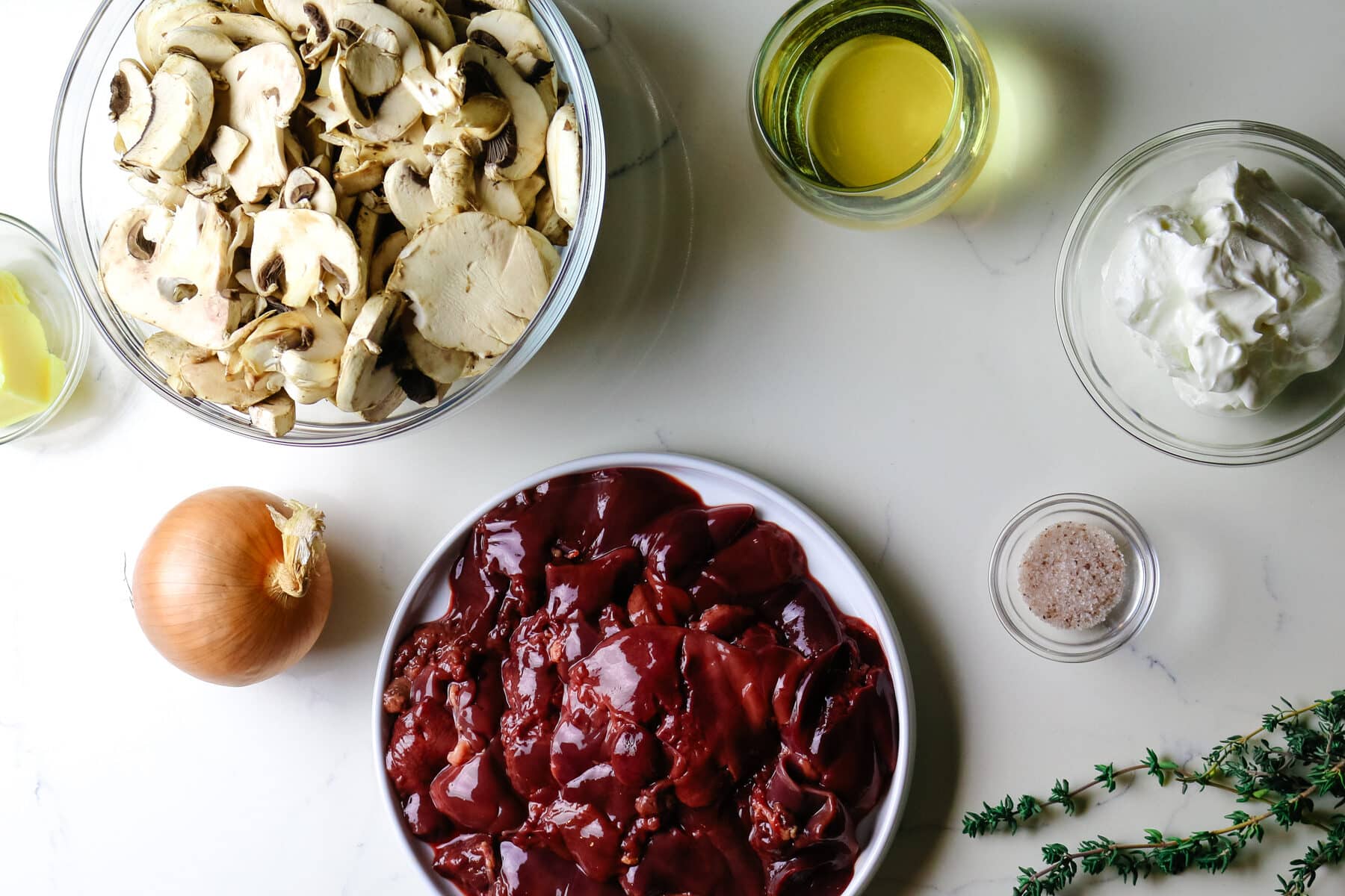 ingredients for creamy chicken livers with mushrooms and white wine.